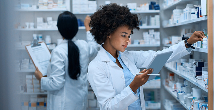 Female pharmacists taking inventory